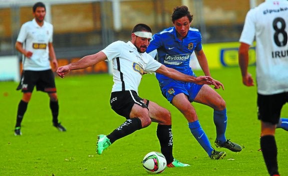 
El defensa unionista Mikel Azkoiti trata de despejar el balón ante el acoso de un jugador del Fuenlabrada ayer en Gal.