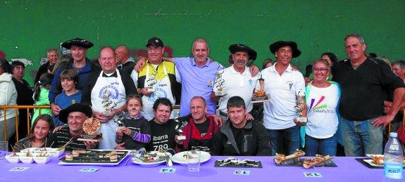 Ganadores del concurso de pintxos y de la piperrada, con sus respectivos trofeos junto a los organizadores. 