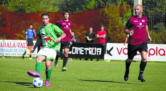 Un jugador local pasa el balón durante un partido. 