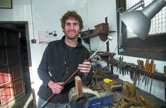 Beñat Alberdi posa en el taller de Irun con una de las más de 400 makilas que elabora al año.