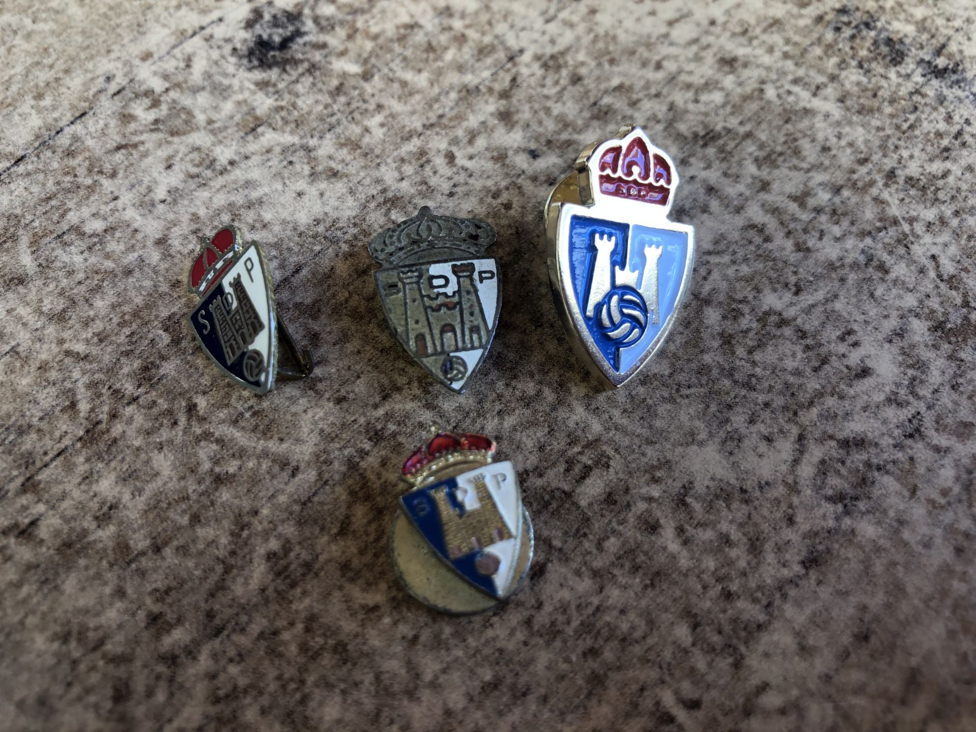 Diferentes pins del socio más veterano de la Deportiva.