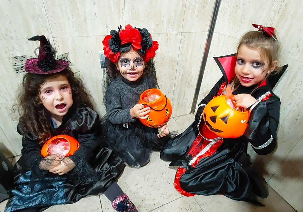 Imagen principal - Pequeños y grandes participan en la celebración de la tradicional fiesta del 'Truco o trato' en la localidad.