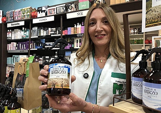 María Pérez muestra en su farmacia de Cacabelos uno de los perfumes que evoca el aroma del Bierzo en primavera.