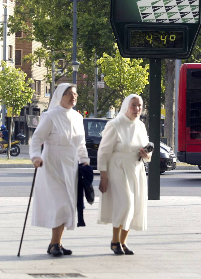 Dos monjas pasan por delante de un termómetro en Zaragoza