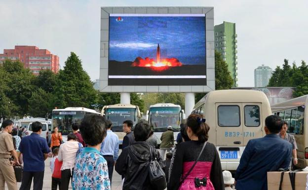 Norcoreanos observan la reproducción del ensayo nuclear.