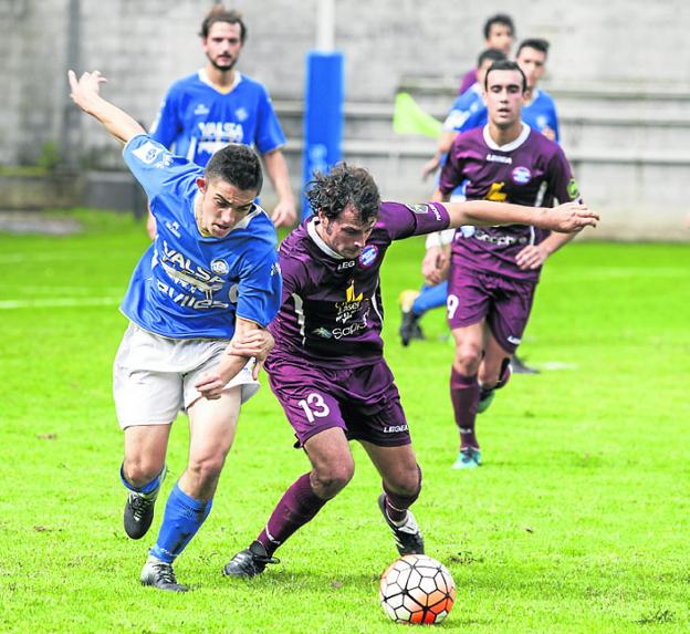 Radamés aguanta el balón ante Óscar. 