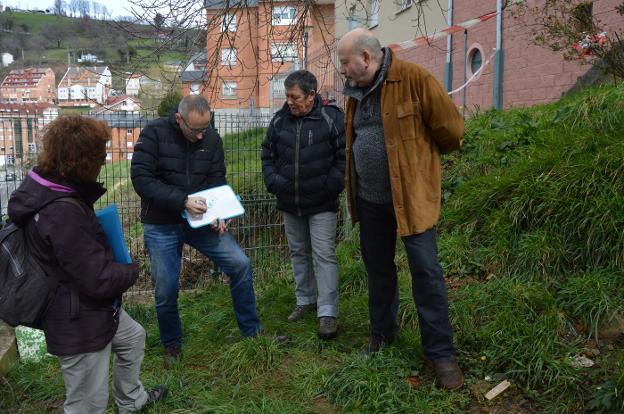 Los vecinos de la calle Claudio Zardaín se reúnen en la parte alta del muro, que separa sus viviendas de la calle Venancio Blanco, para escuchar las explicaciones del profesor universitario, Carlos López. 
