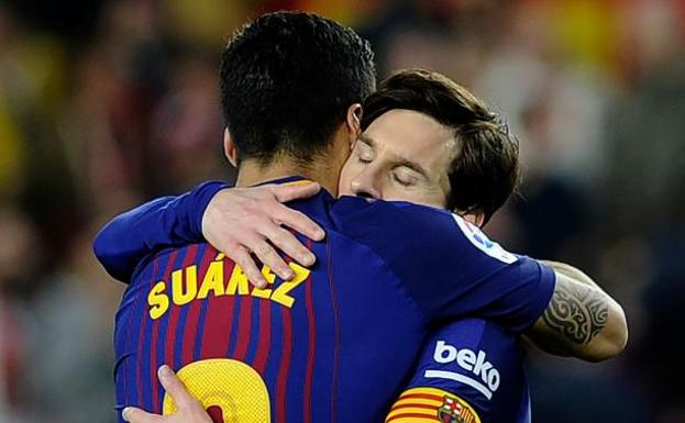 Luis Suárez abraza a Messi. 