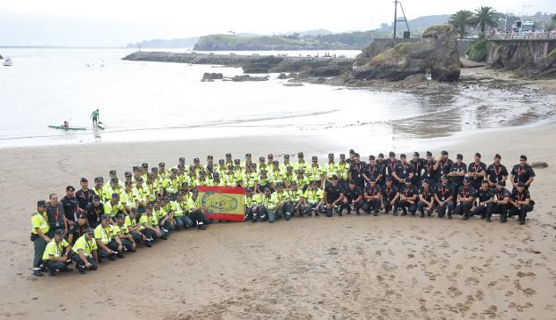 Parte del dispositivo desplegado por la Guardia Civil de Tráfico posa en la playa de Candás antes del comienzo de la prueba. 