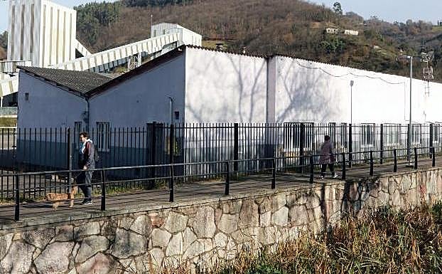 El edificio del lavadero Batán con amianto que va a ser derruido, junto al paseo fluvial del río San Juan en Mieres 