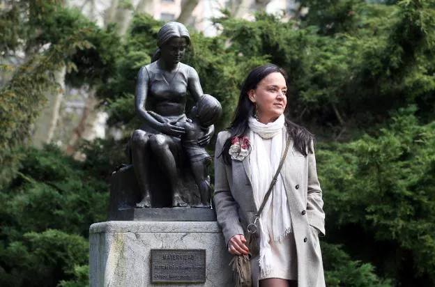 Marina Menéndez, ante la estatua de la maternidad, en Oviedo. 