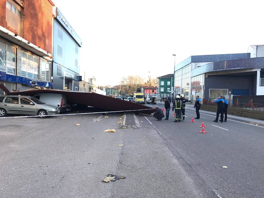 Parte de la estructura de la techumbre de una nave ha caído causando daños sobre siete vehículos. No hay heridos. La calle ha sido cortada para proceder a retirar el escombro