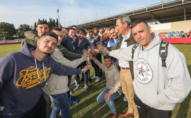 La plantilla del Navarro con el entrenador y el presidente en el día después del ascenso, repitiendo el brindis por el éxito conseguido.