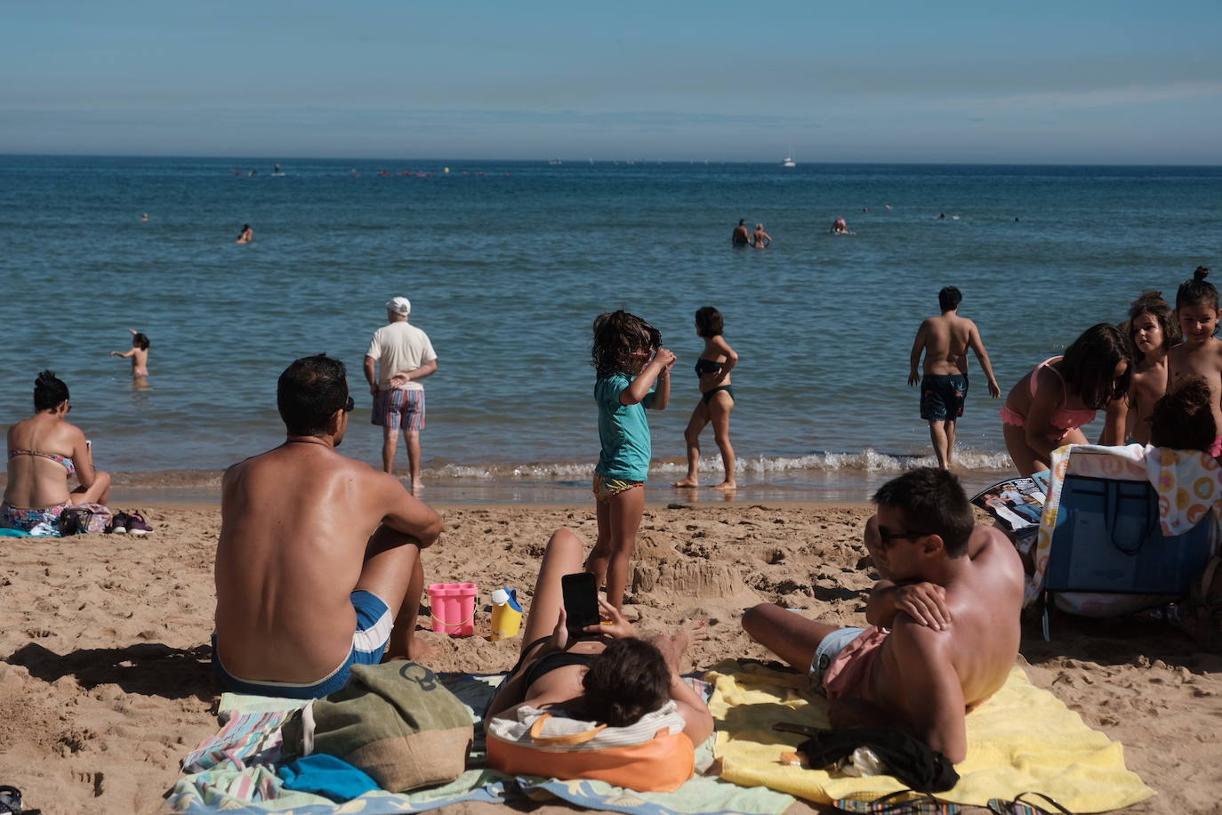 Un baño en la playa para combatir el calor en Gijón