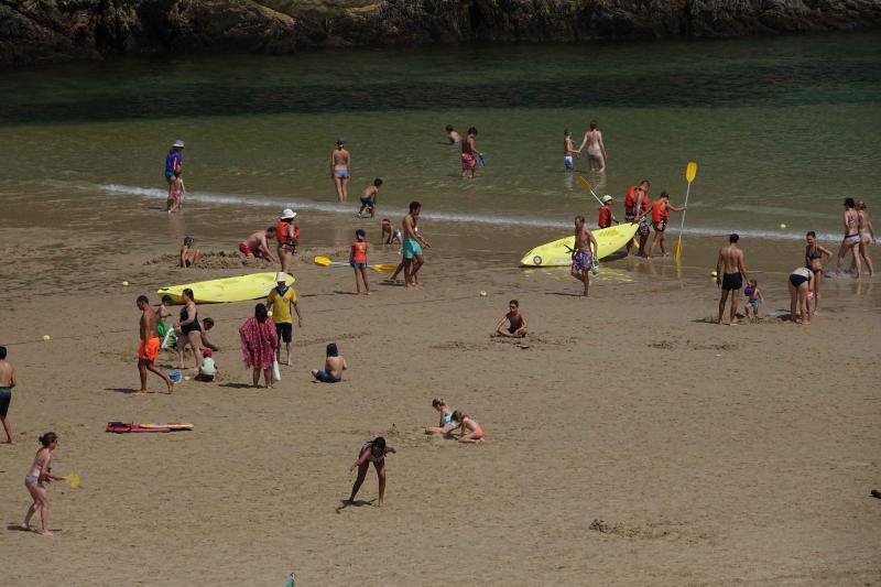 Un baño en la playa para combatir el calor en Gijón