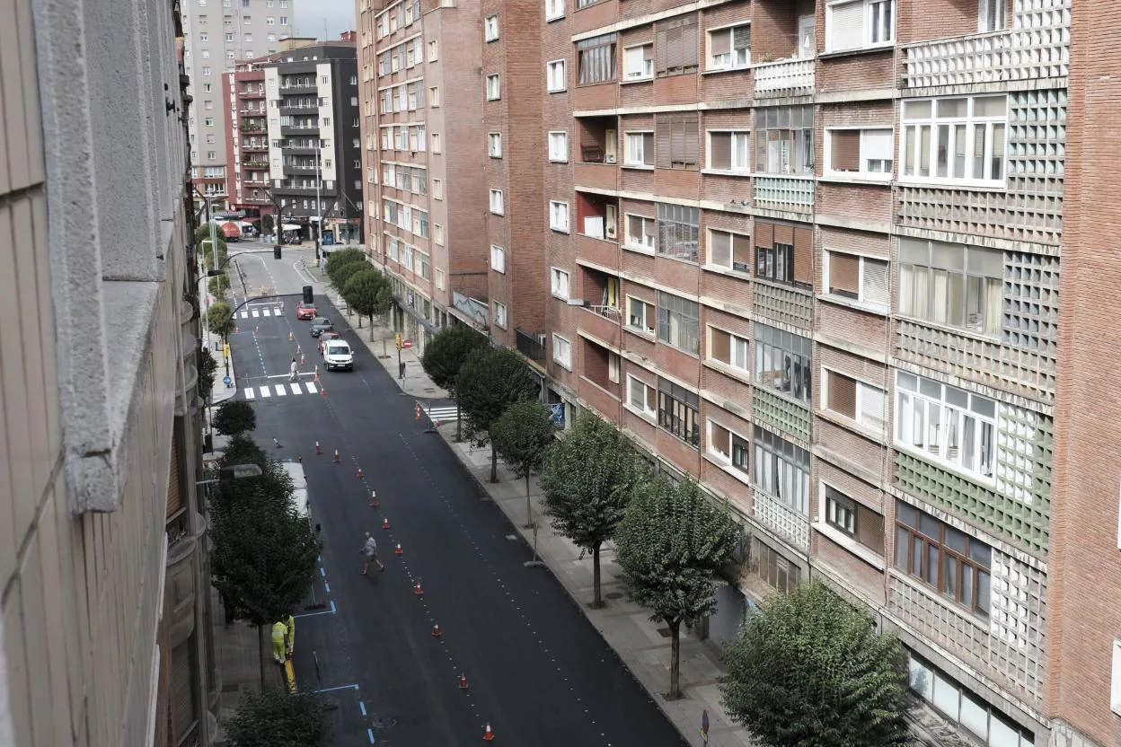 La calle de Manuel Llaneza, con un carril abierto a la circulación y los obreros comenzando a pintar la calzada. 