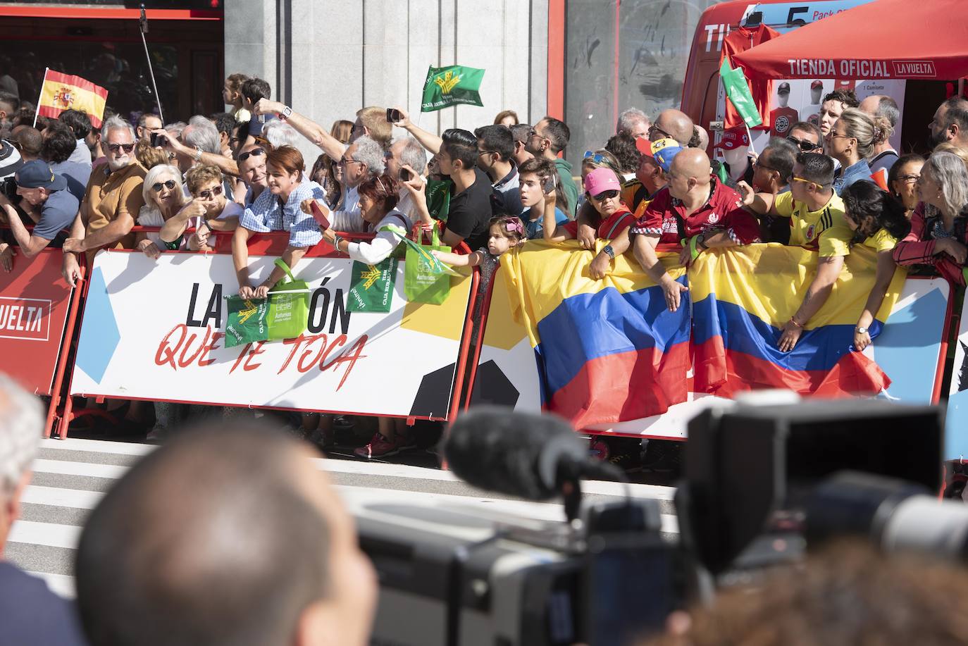 Numerosos aficionados se agolparon en la calle Uría de la capital para ver a los corredores en la etapa 14 entre San Vicente de la Barquera y Oviedo. 