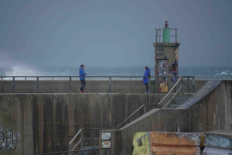 Olas de casi ocho metros en algunas zonas, alerta naranja por fuentes vientes y oleaje y Protección Civil recomendando alejarse de las zonas costeras. Aún así, algunas personas desafiaron el temporal para tomarse una foto en el puerto de Llanes, junto a los cubos de la Memoria de Ibarrola.