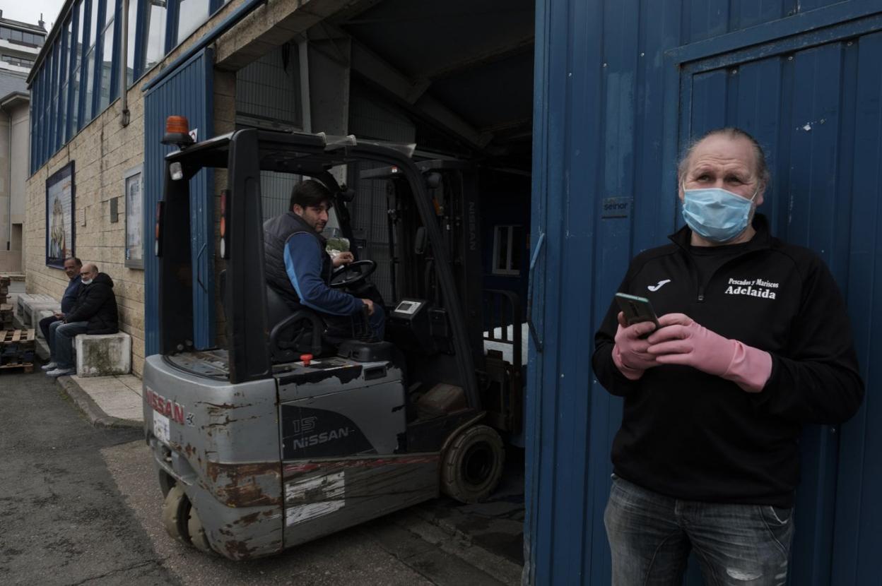 Pescadores en el muelle de Luarca descargan mercancía. 