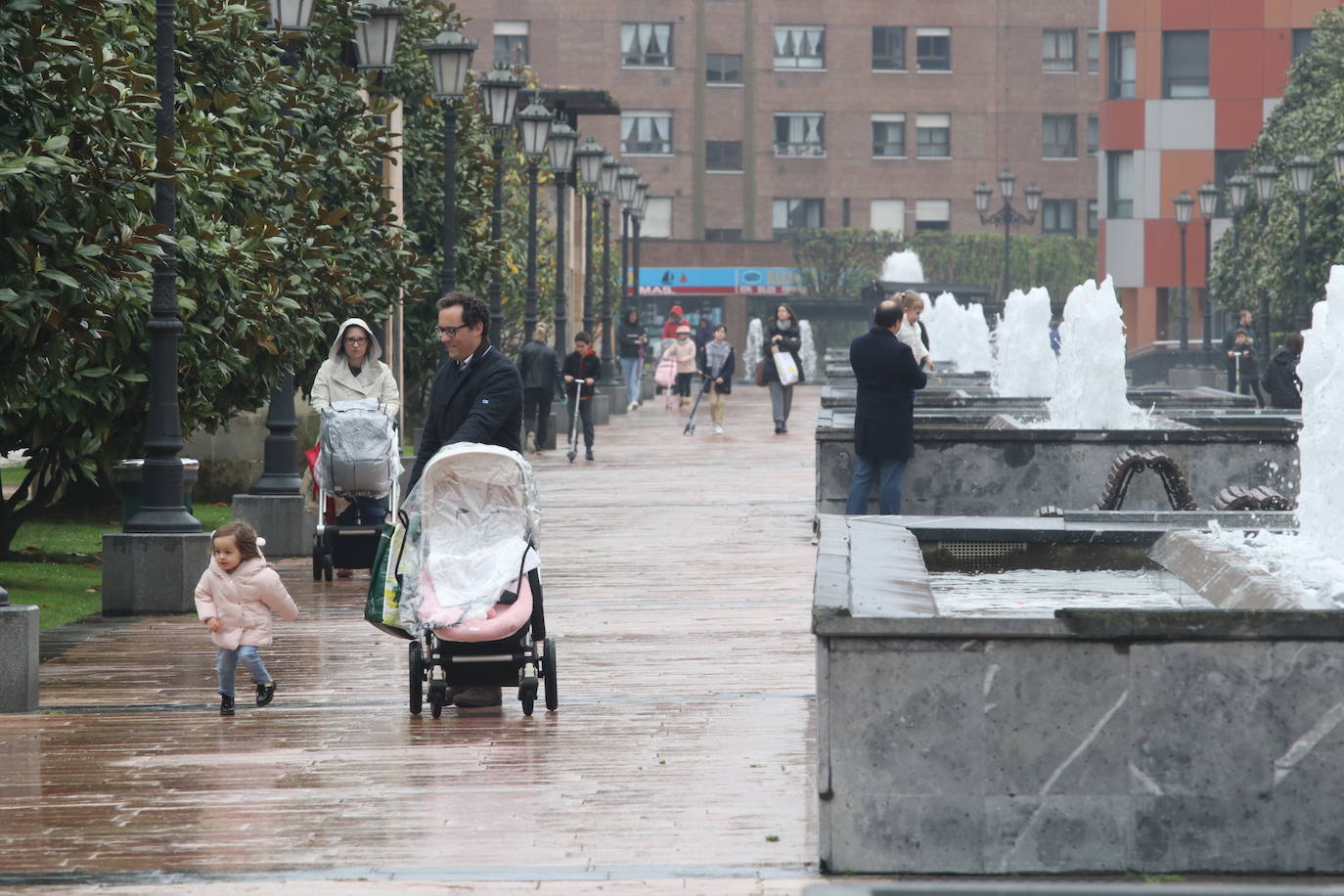 Los niños de Oviedo ponen al mal tiempo buena cara y salen a disfrutar de sus calles