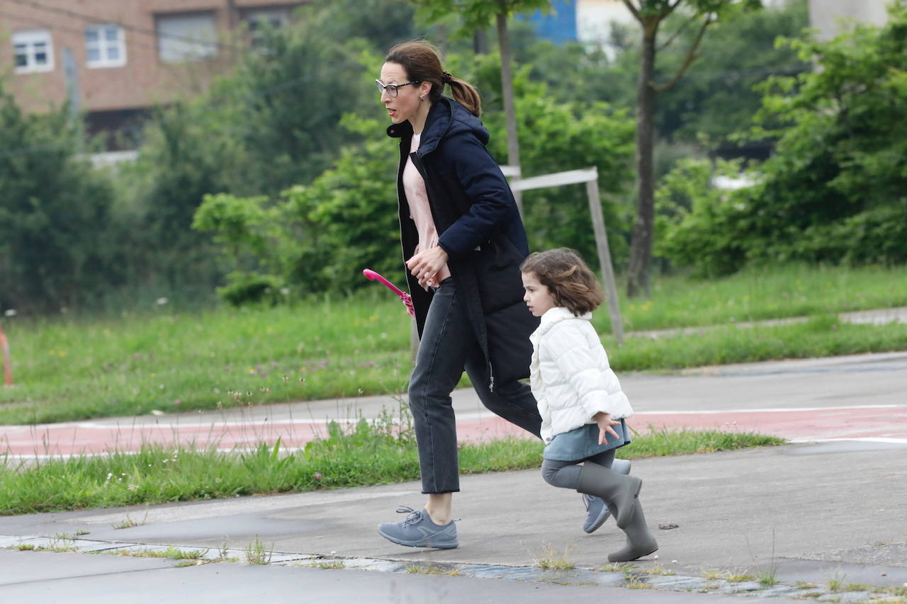 Primeros paseos bajo el orbayu en Gijón de los más pequeños