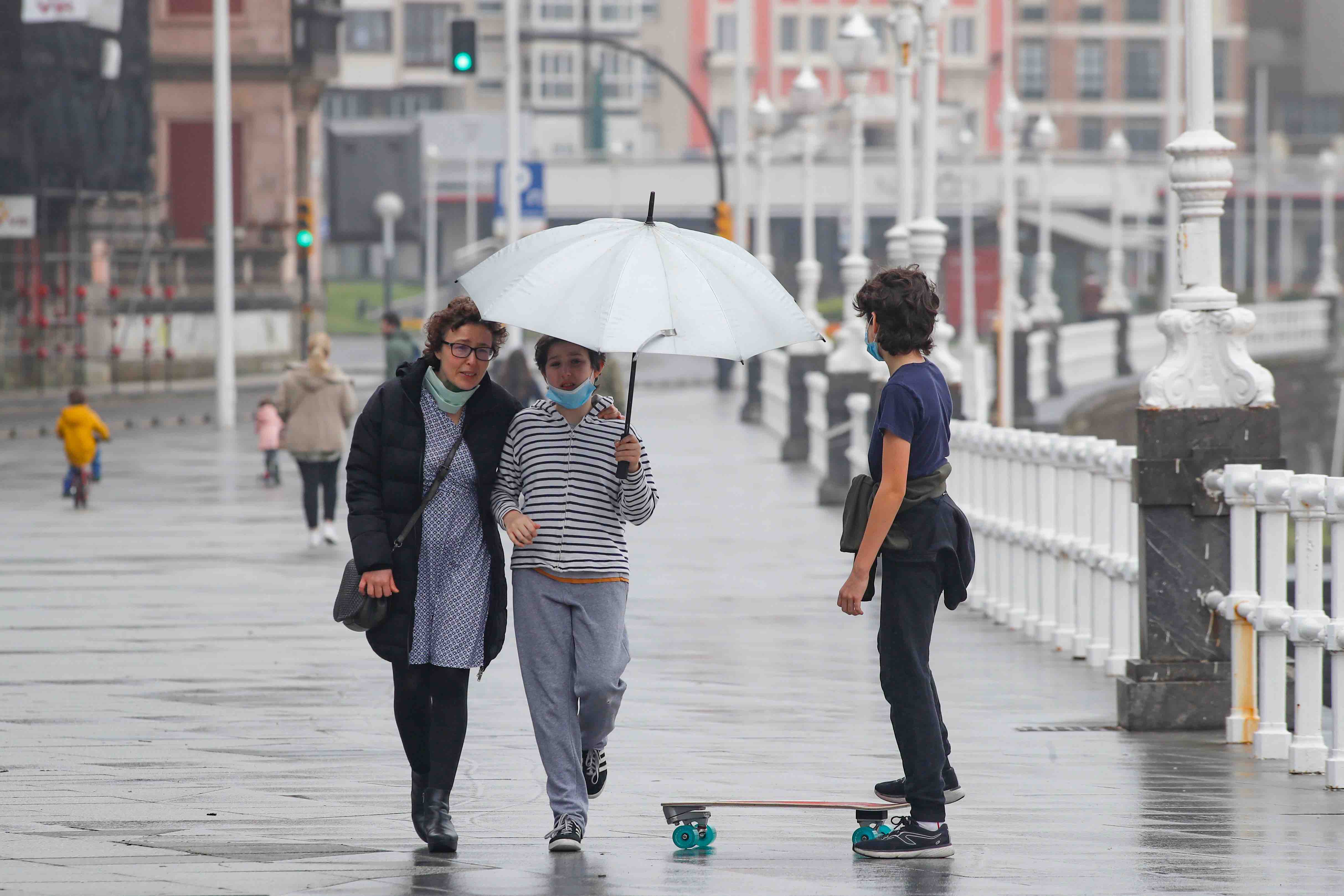 Primeros paseos bajo el orbayu en Gijón de los más pequeños