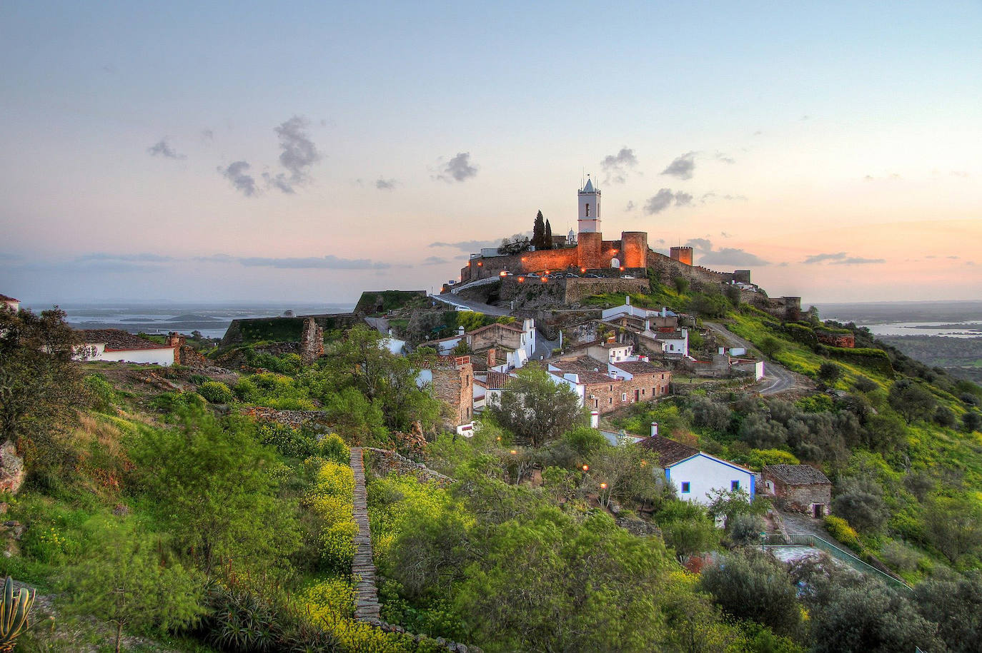 Monsaraz (Portugal): Aislada en cierto modo del resto de Portugal, lo que le da una sensación de total serenidad, el pueblo de Monsaraz se alza sobre el impresionante Valle del Guadiana, con las granjas circundantes a poca distancia. Está completamente rodeado por grandes muros de ladrillo tradicional portugués que se construyeron originalmente en la época medieval para mantener alejados a los intrusos. En la selección realizada por Jetcost.es se valoran dos cosas más sobre Monsaraz: aquí se elaboran magníficos vinos y hay muchas bodegas que visitar y tiene unas espectaculares puestas de sol.