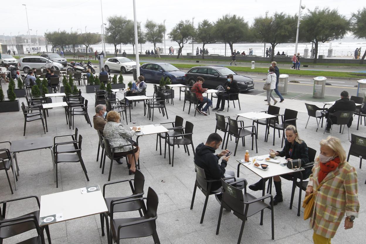 Usuarios de una terraza situada frente al Muro. 