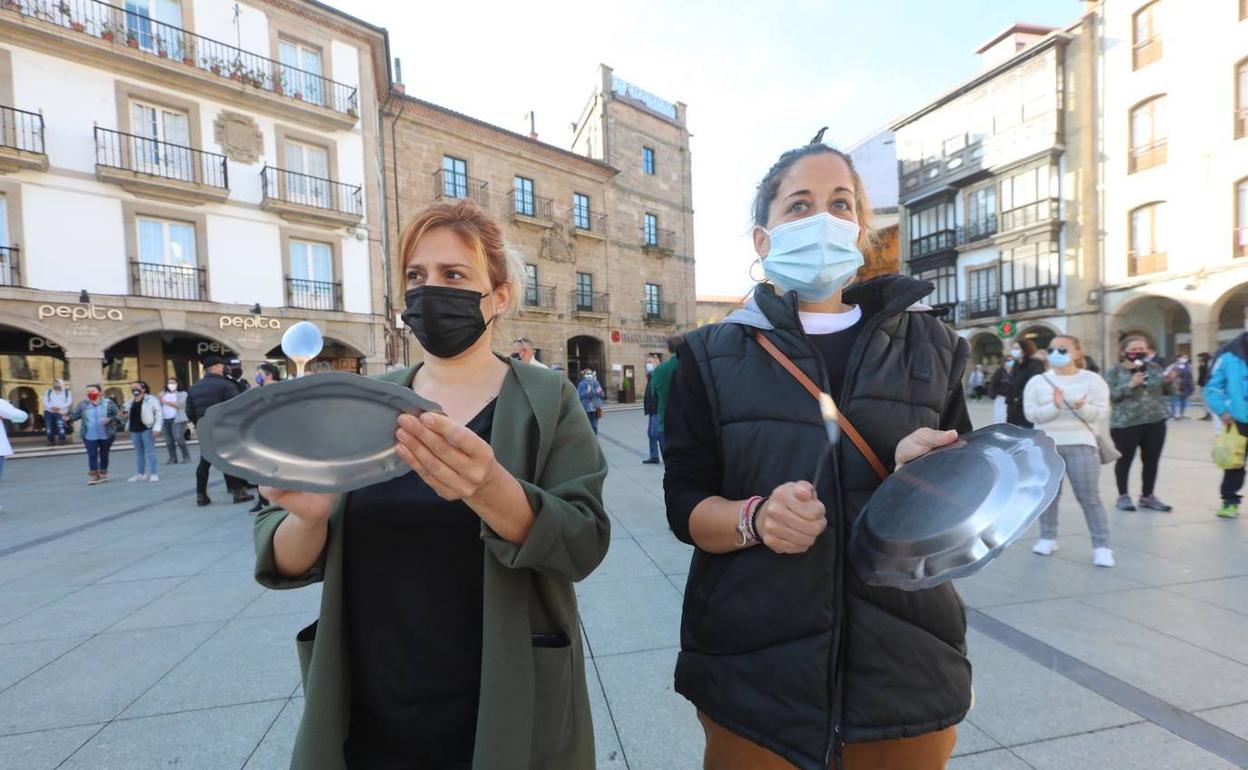 Dos hosteleras del Carbayedo protestan en la Plaza de España. 