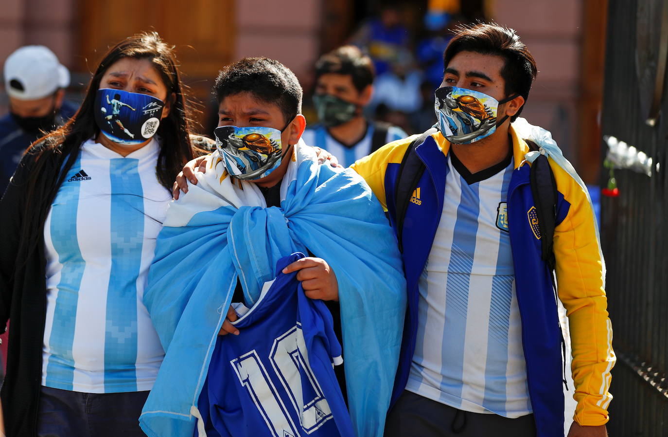 Aficionados argentinos salen llorando del velatorio de Maradona.