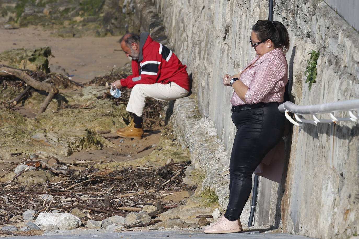 Las agradables temperaturas de este jueves y el sol permitieron que muchos gijoneses optasen por disfrutar de El Muro y de la playa en pleno mes de enero.