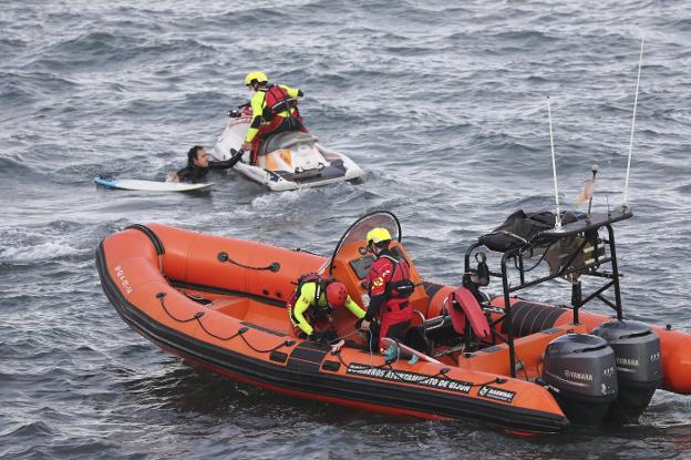 Momento del rescate de los dos surfistas por parte de los bomberos, a la altura de la escalera 0. 