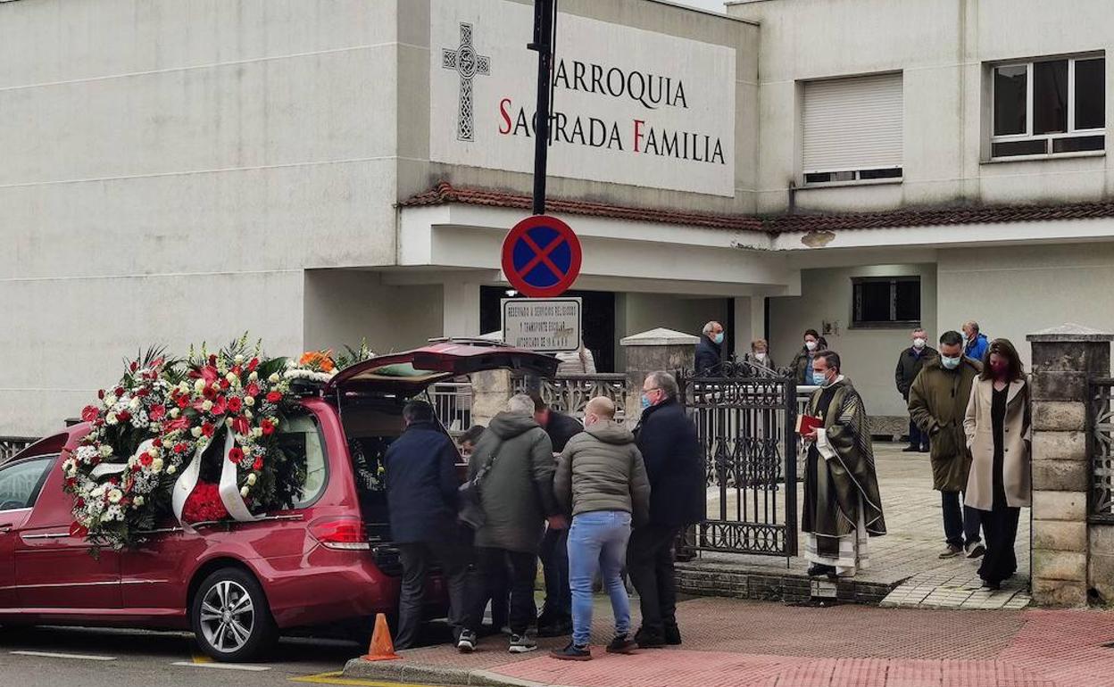 Familiares y amigos de Juan Carlos Ortiz introducen su ataud en el coche fúnebre en presencia del párroco de Las Vegas, José Alejandro Sole. 