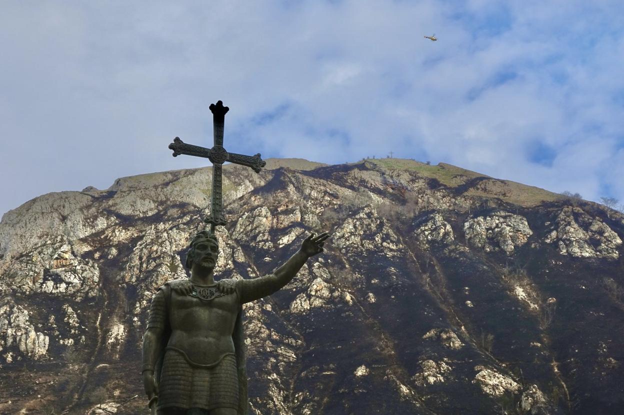 La estatua de Pelayo con el monte Priena calcinado. 