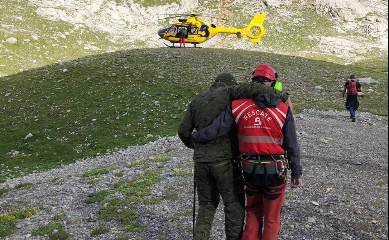 El militar es ayudado por el médico rescatador a llegar al helicóptero.