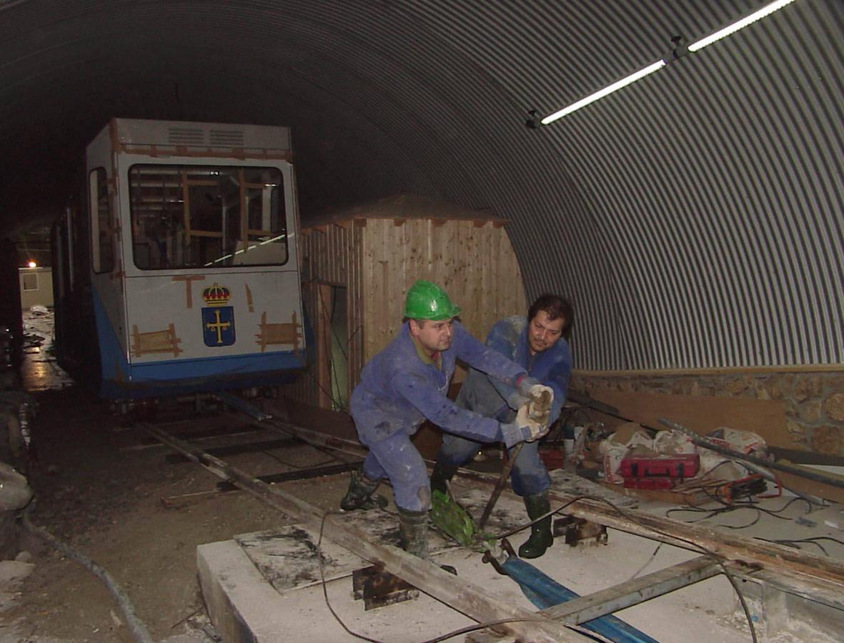 Dos operarios ultiman los trabajos de la instalación de la maquinaria ferroviaria. 