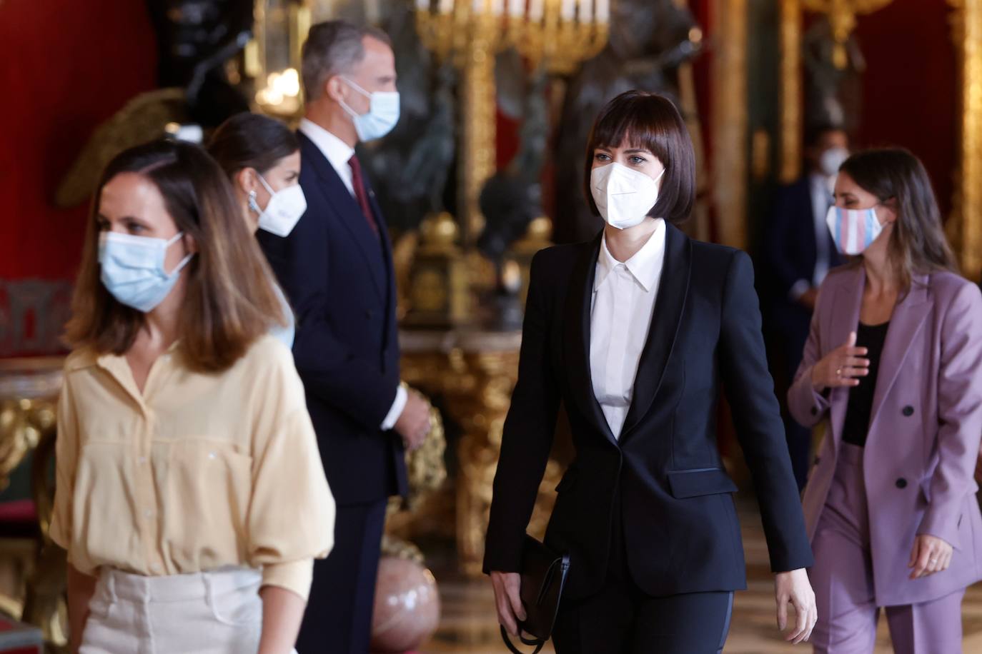 El Palacio Real de Madrid ha acogido la tradicional recepción que los Reyes ofrecen con motivo de la Fiesta Nacional y que el año pasado tuvo que suspenderse por la covid. Esta vez, el número inferior de invitados ha sido menor al habitual, unos 200, y ha sido imprescindible prescindir de bebidas y llevar la mascarilla para cumplir con las normas vigentes.