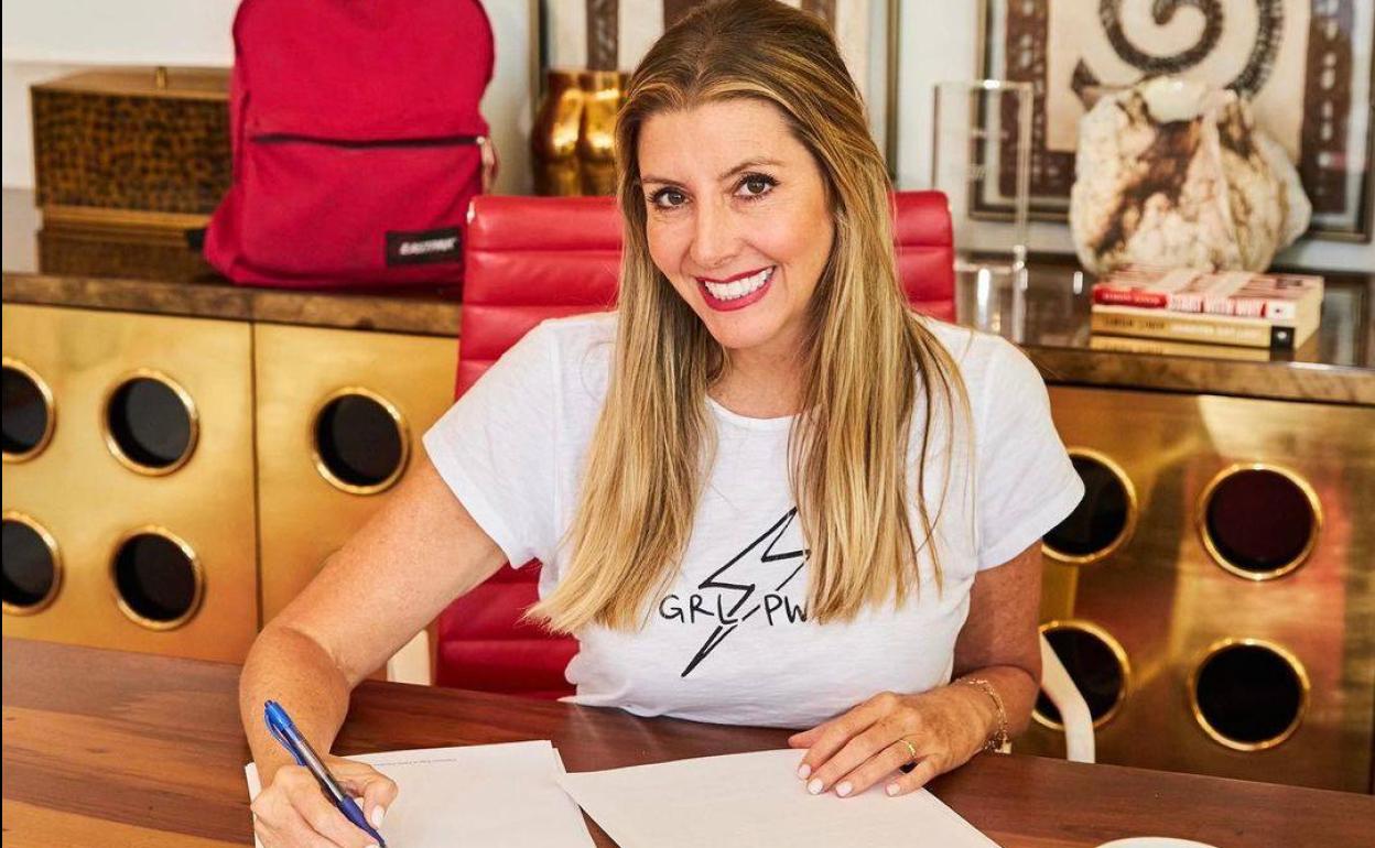 Sara Blakely, CEO y fundadora de Sapanx firmando un acuerdo con el banco de inversión Blackstone.