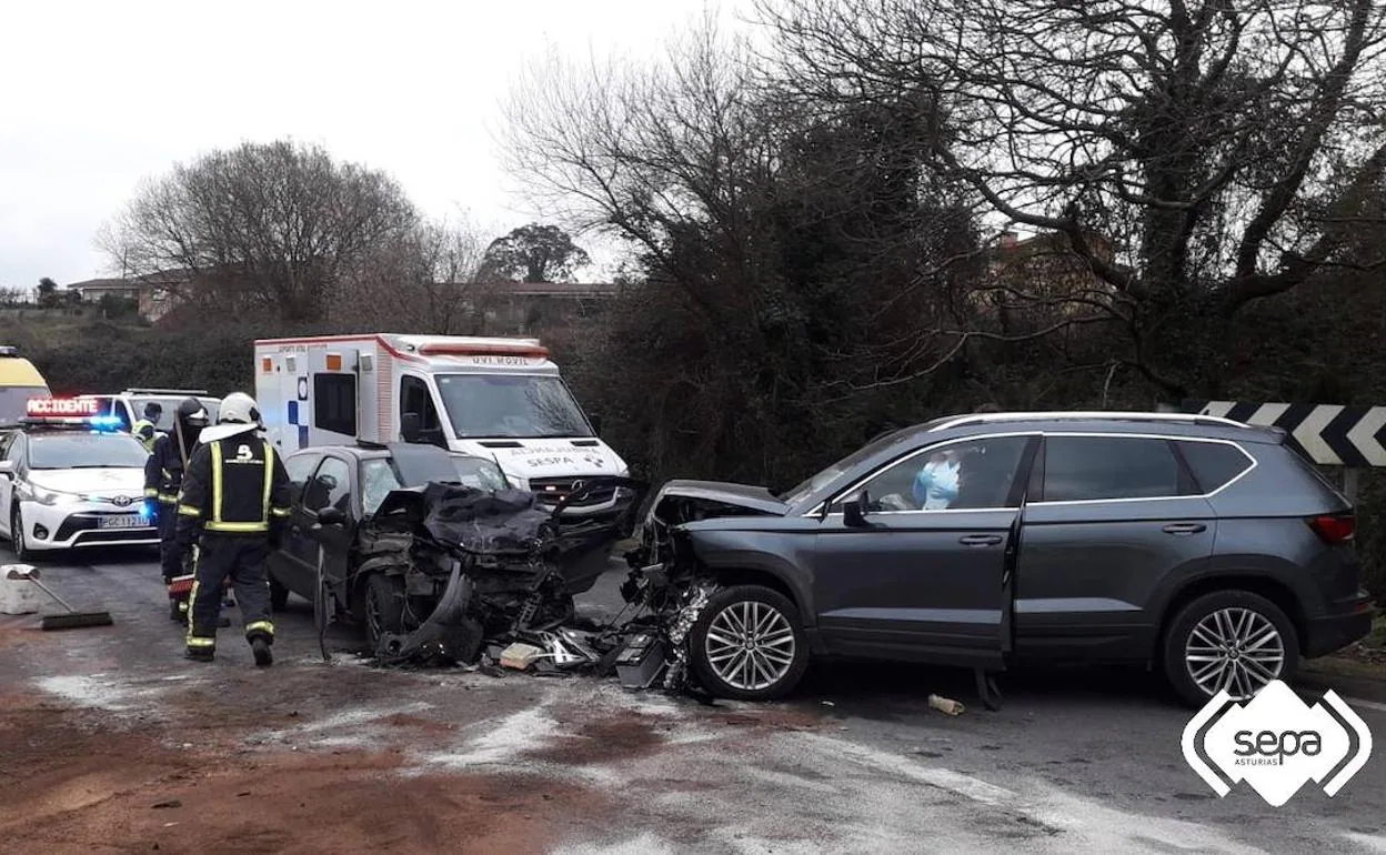 Bomberos y sanitarios, con los dos coches implicados en el accidente. 