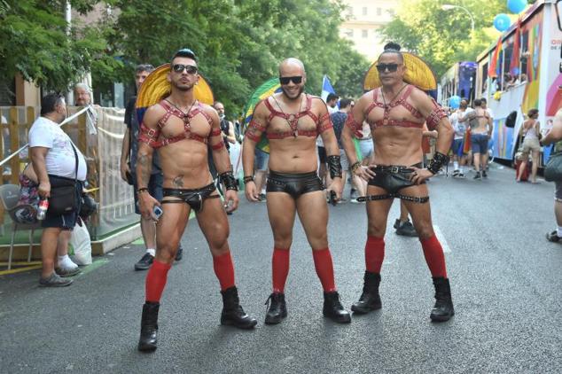 Tres participantes posan ante del comienzo de la manifestación del Orgullo. 