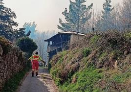 Bomberos de la BRIF de Tineo inspeccionan por dónde introducir las motobombas en Porciles.