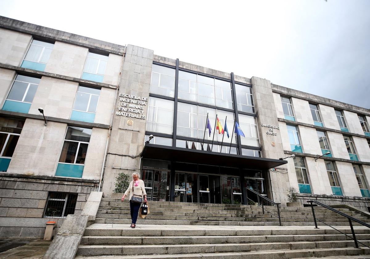 Una mujer baja por las escaleras de la entrada principal a la Escuela de Minas de Oviedo, cuyo traslado a Mieres ha sido paralizado.