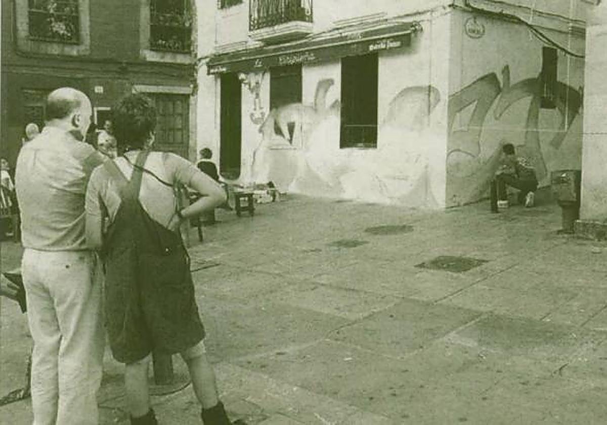 Visitantes a Cimadevilla contemplan la muestra de arte urbano.