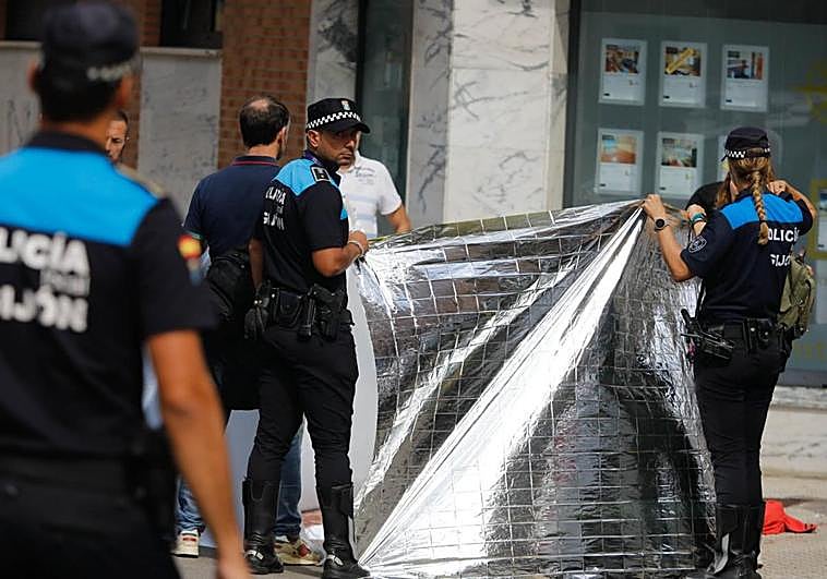 Policías ocultan con una manta térmica el cuerpo sin vida del gestor inmobiliario.
