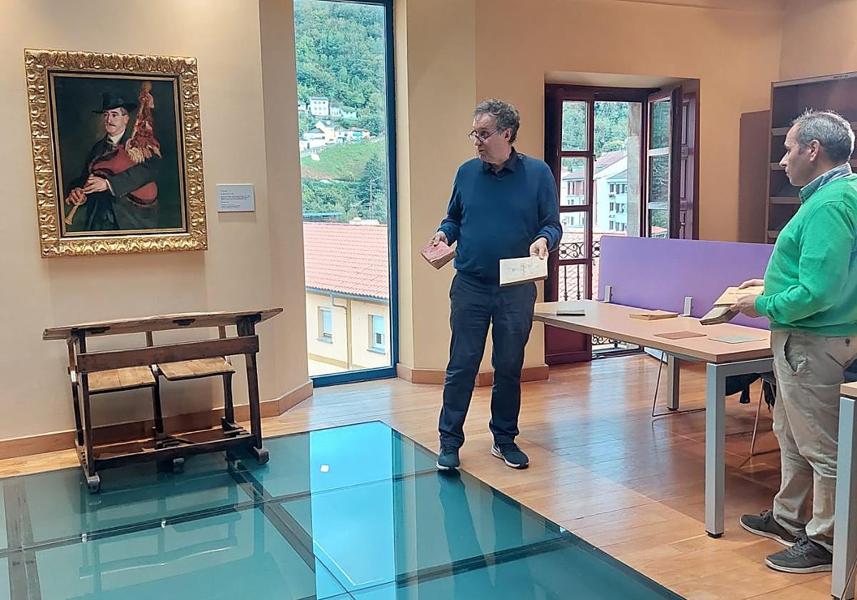 El historiador Juaco López y Benito Álvarez, secretario de Tous pa Tous, ante el cuadro recién colocado.