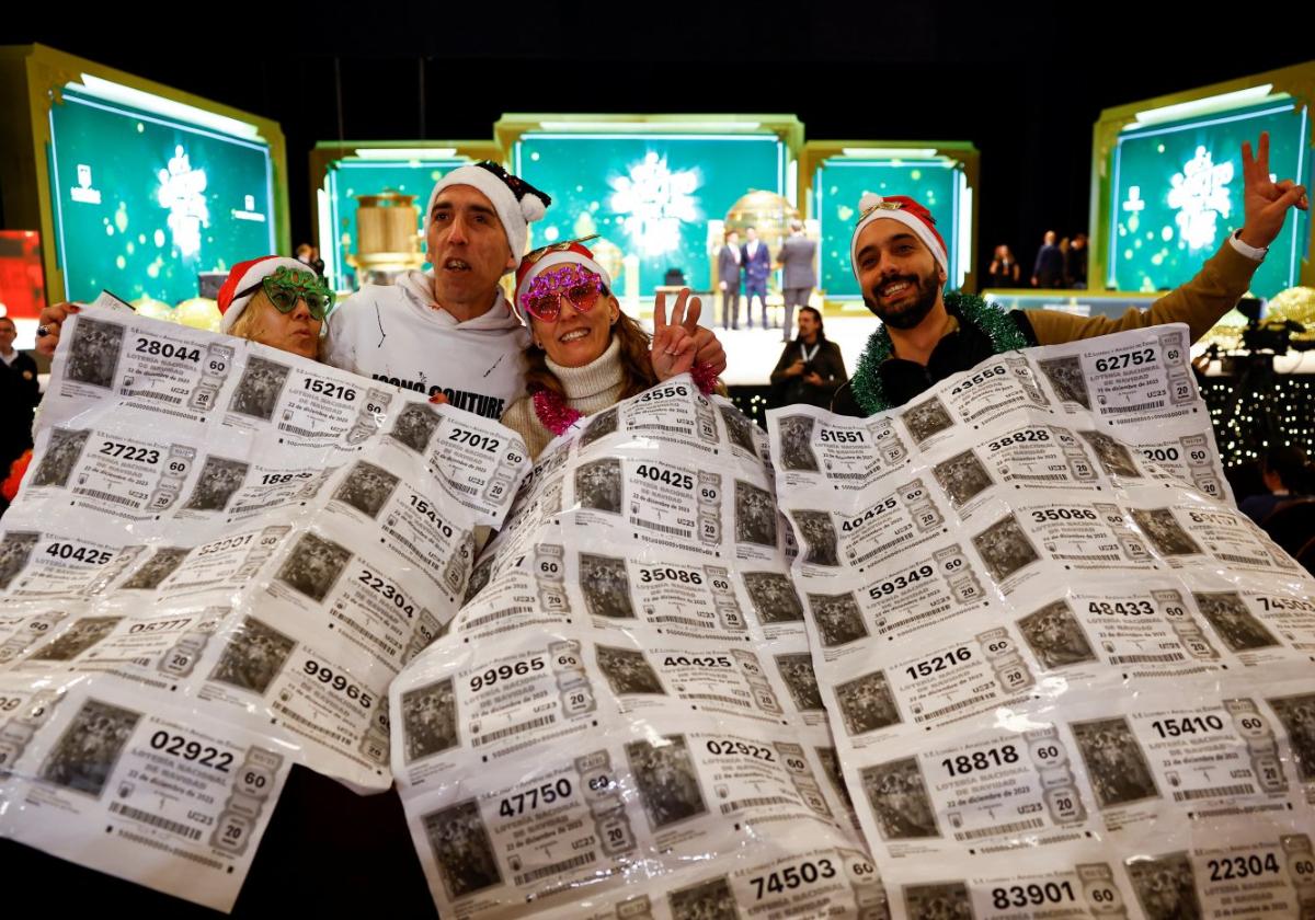 Los más fans Varios fans del sorteo de Navidad se fotografían con los bombos al fondo.