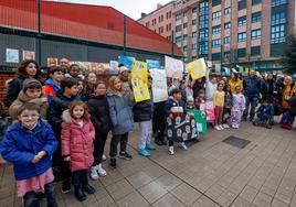 Alumnos del colegio Rey Pelayo, acompañados de padres, madres y docentes delante del centro educativo cuando se cumple un año del derrumbe de un aula.