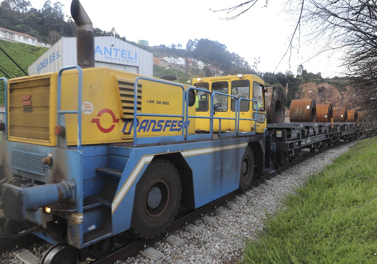 Vehículo híbrido, con capacidad de remolcar carga sobre vía ferroviaria y carretera, en el puerto de Gijón.