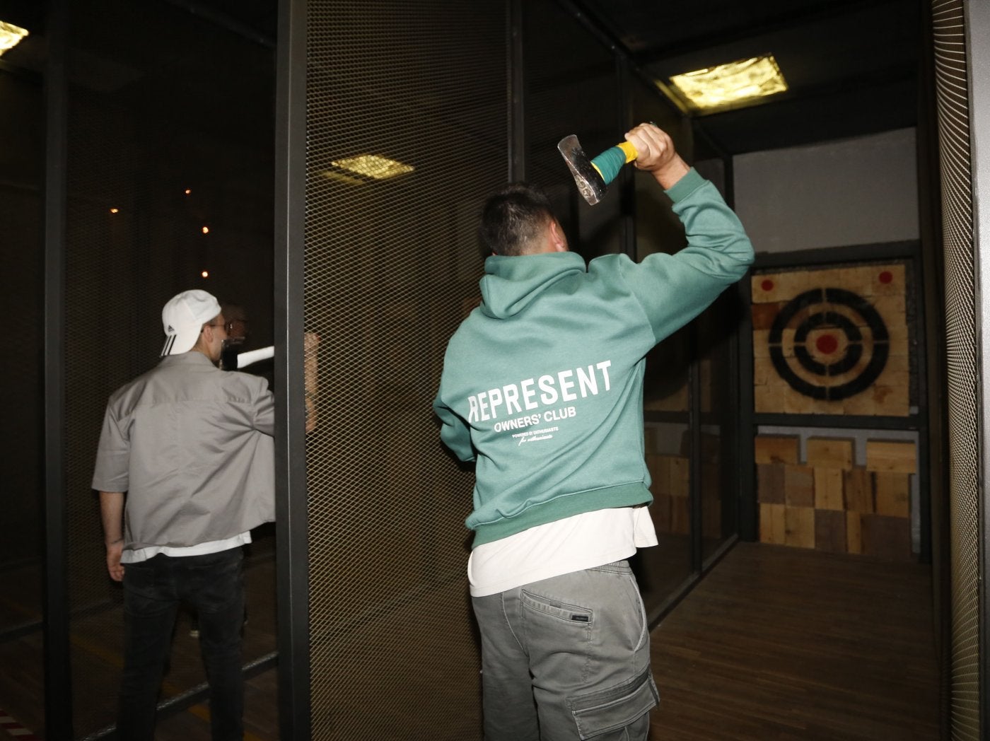 Lanzadores de hachas poniendo a prueba su puntería con la diana en el establecimiento.