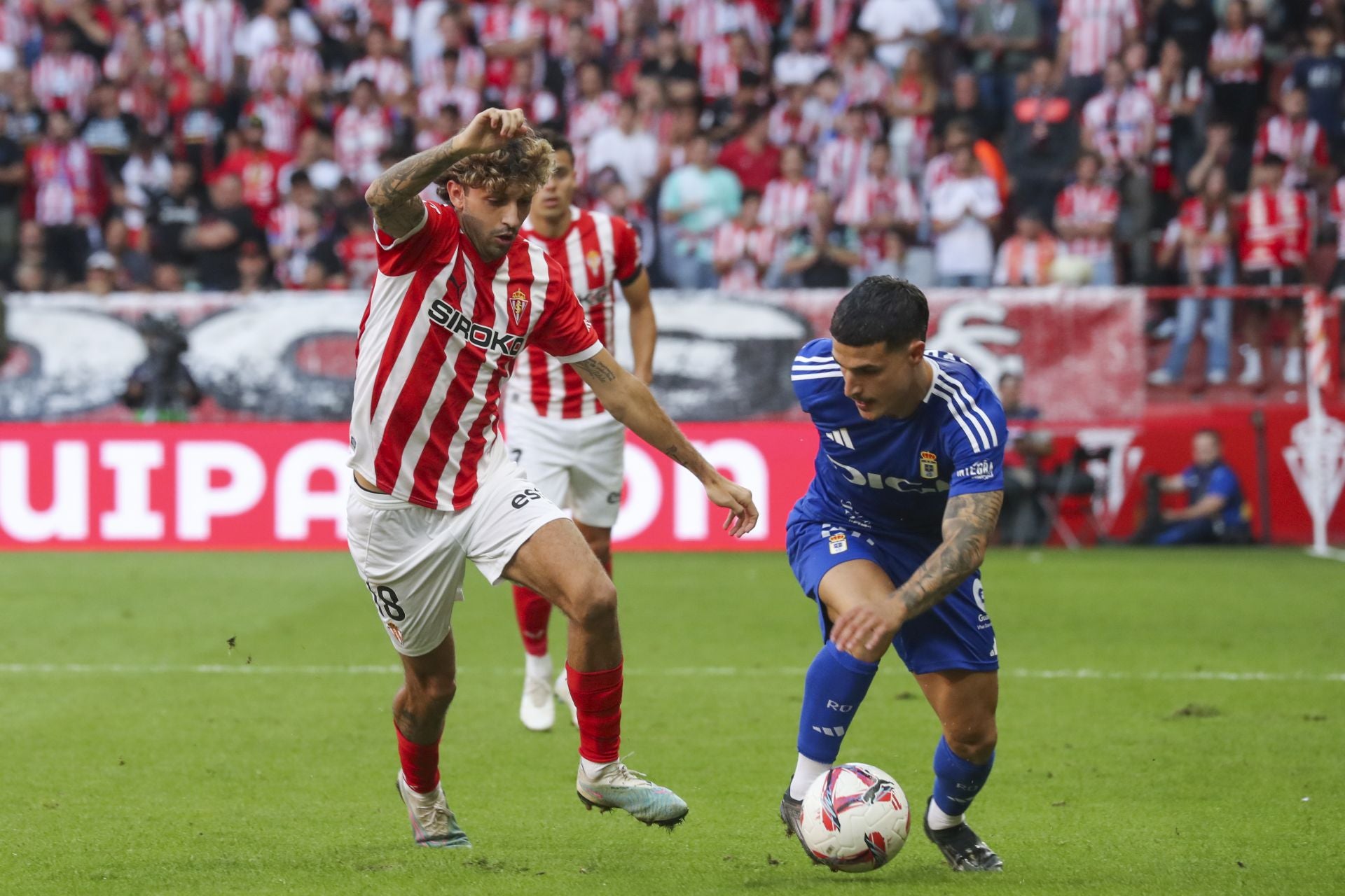 Jaime Seoane conduce el balón en un lance del derbi de la primera vuelta, ante la atenta mirada de César Gelabert.